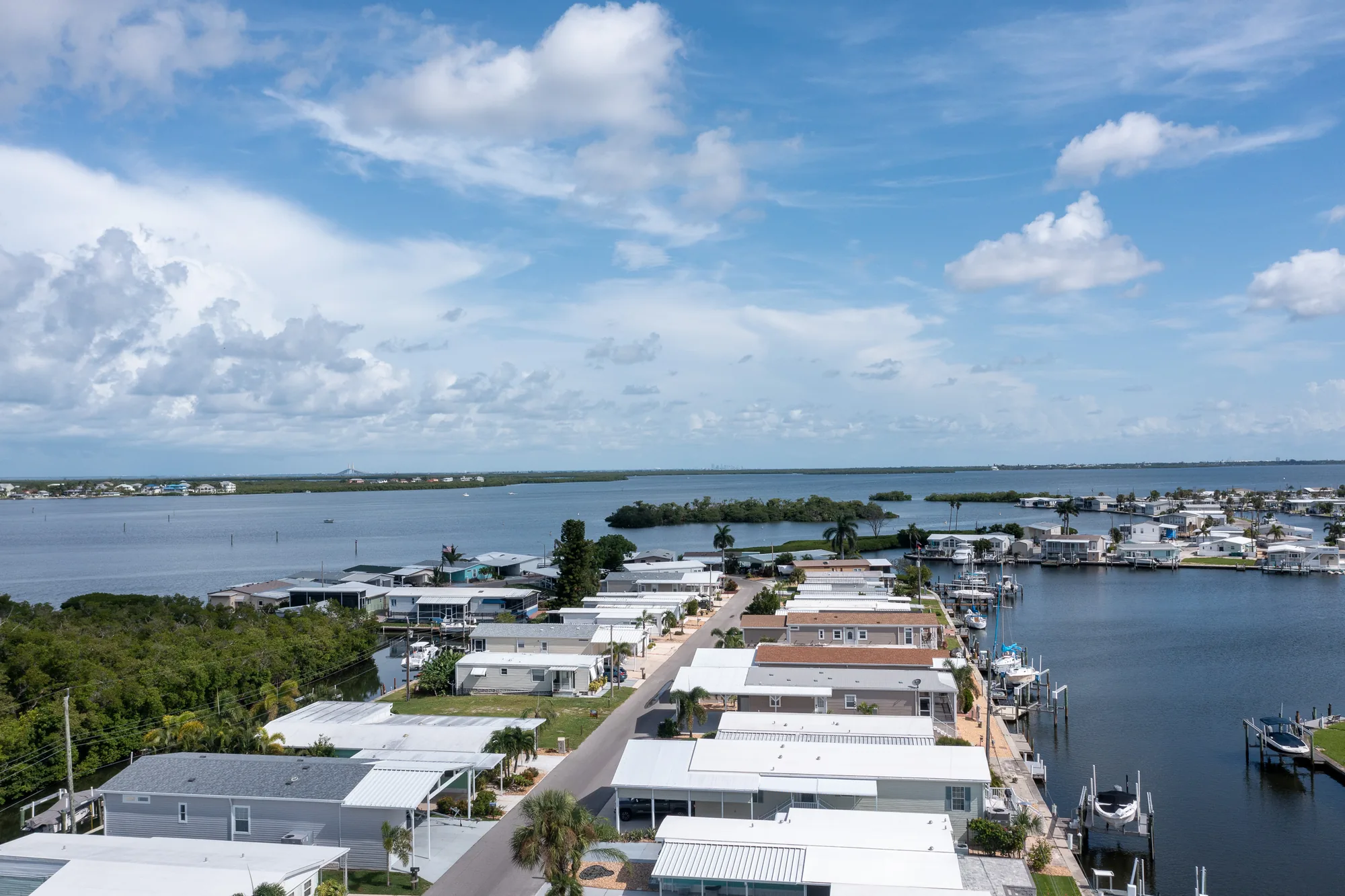 Aerial view over Tropic Isles toward Terra Ceia Bay, with canal-front homes and docks